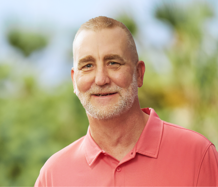 Doug, a smiling man with a white beard and a red shirt