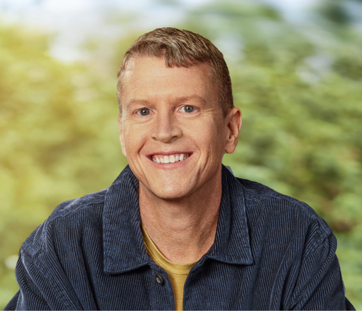 Mike, a smiling man with blonde hair and a black shirt